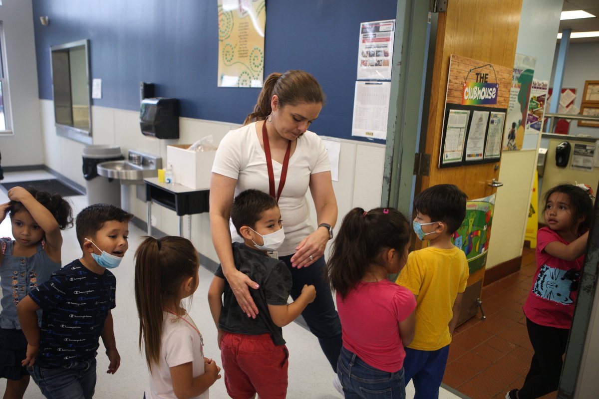 Michelle Cardenas watches over her students as students wait in the lunch line at Hillcrest Elementary School on April 21, 2022.