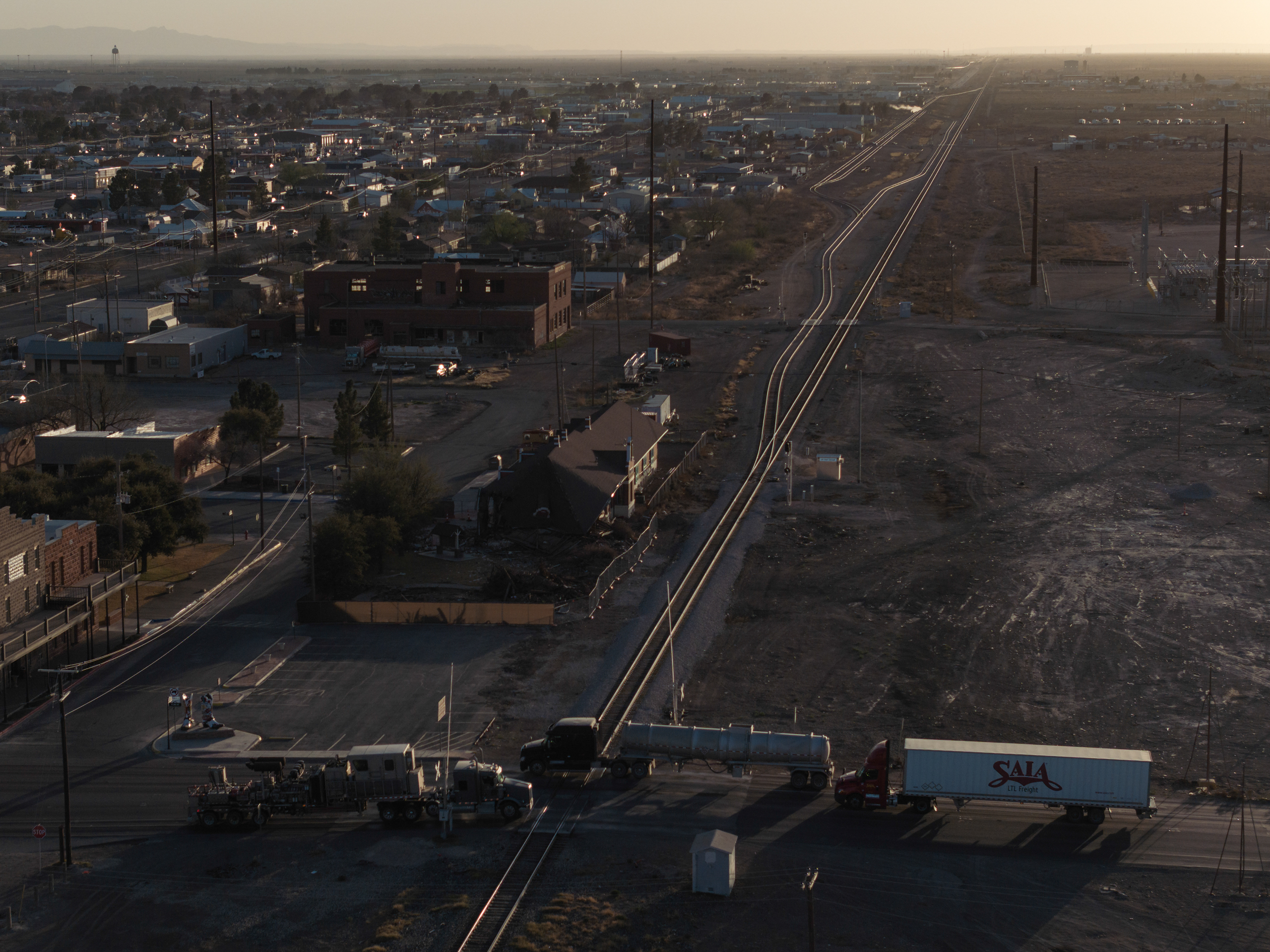 Oilfield traffic crosses over the US Highway 285 railroad crossing, bottom, on March 21, 2025 in Pecos.