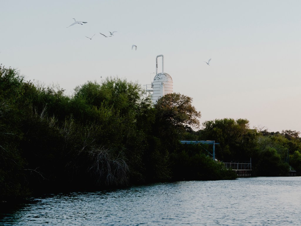 A tank from Celanese Plastics towers over the horizon on the Nueces River.