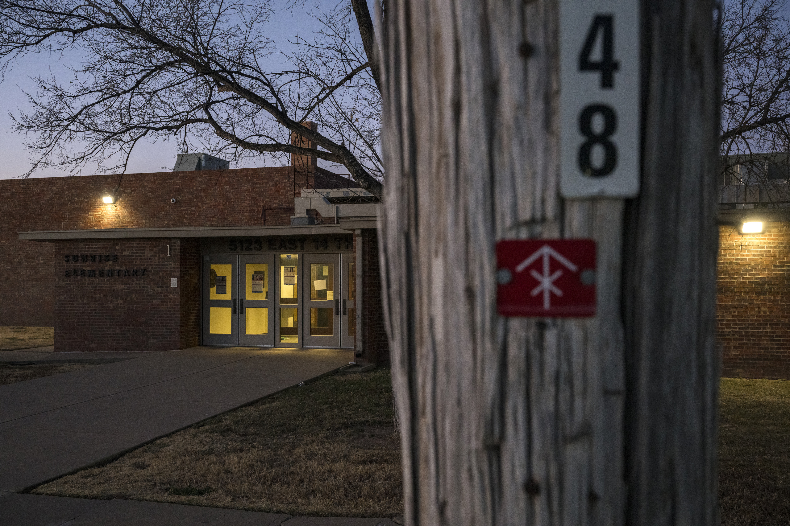 A red-tagged utility pole outside Sunrise Elementary School in Amarillo. The pole, which is not owned by Xcel, stands as a reminder that the region's infrastructure is in constant need of repair. Eli Hartman for The Texas Tribune