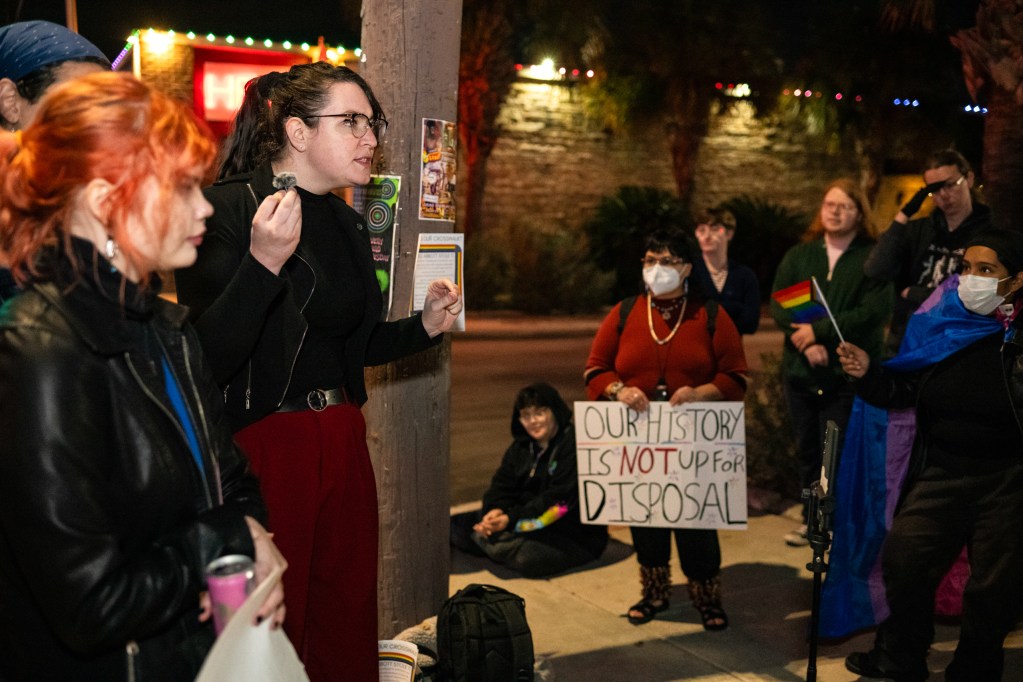 Matilda Miller, 6W Project President, speaks to protestors after the removal of the rainbow crosswalk at the intersection of North Main Avenue and Evergreen Street on Jan. 13, 2026 in San Antonio. The 6W Project, an Austin-based queer rights group, organized the demonstration.