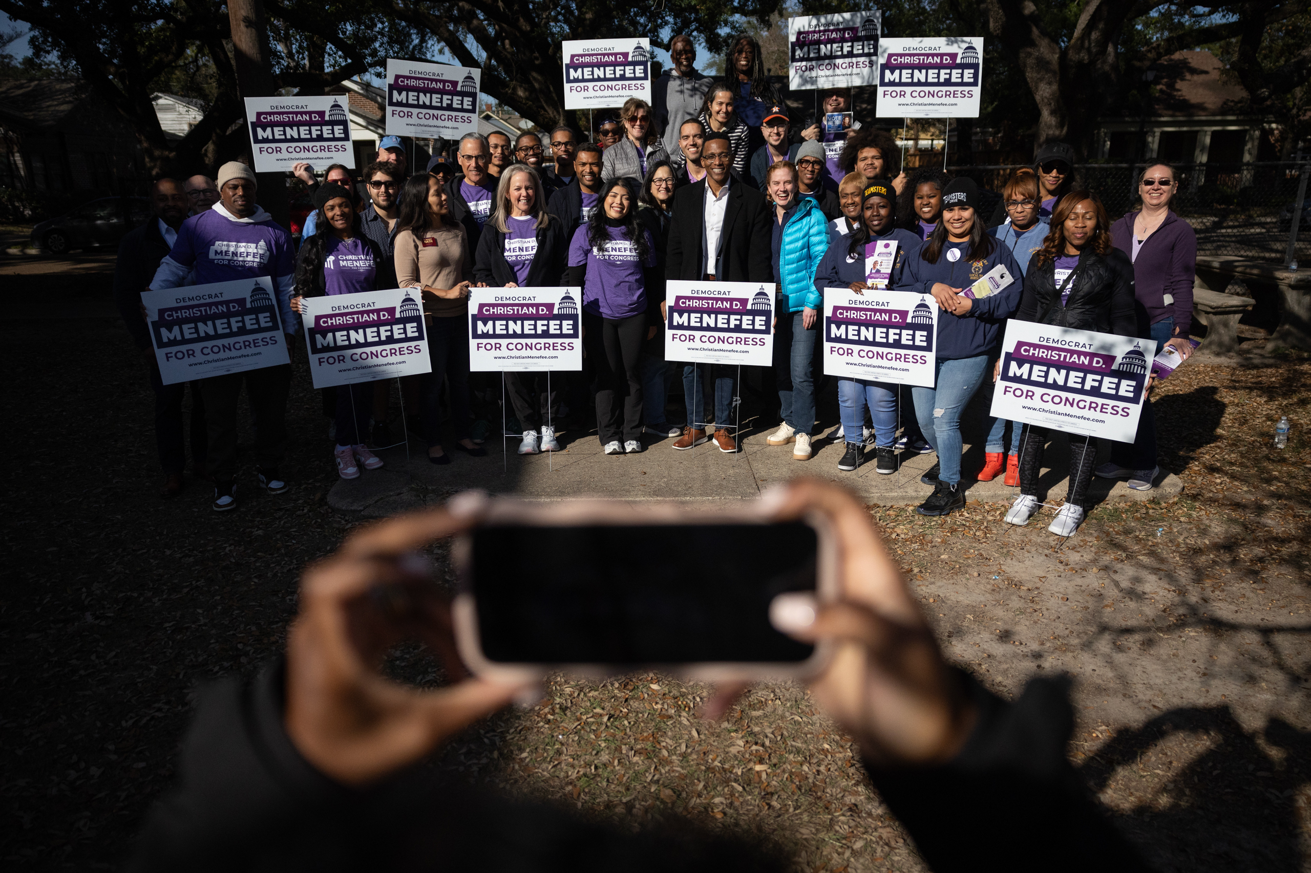 Christian Menefee, candidate for Texas’s 18th Congressional District, poses for a photo with campaign supporters before they begin knocking doors on Jan. 17, 2026, in Houston.