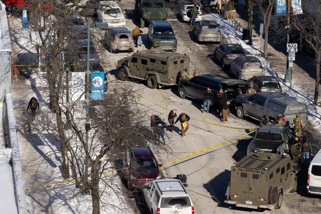 FBI agents work at the scene of the Pretti shooting.