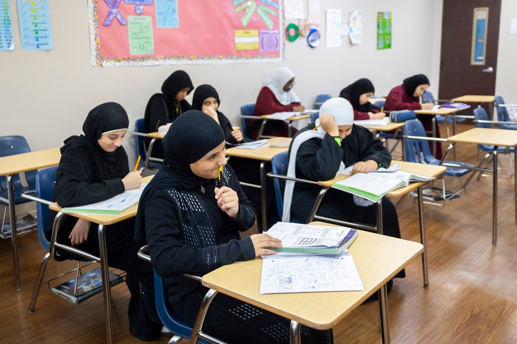 Students smile during class at Iman Academy.
