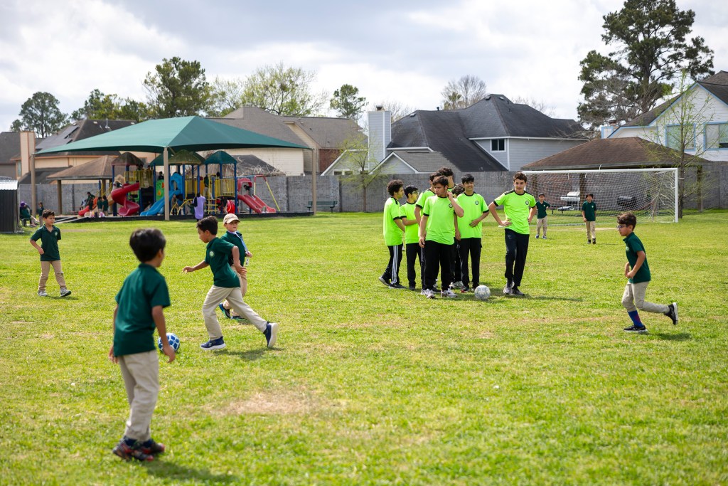 Slideshow: Students at recess run through soccer practice at Iman Academy.