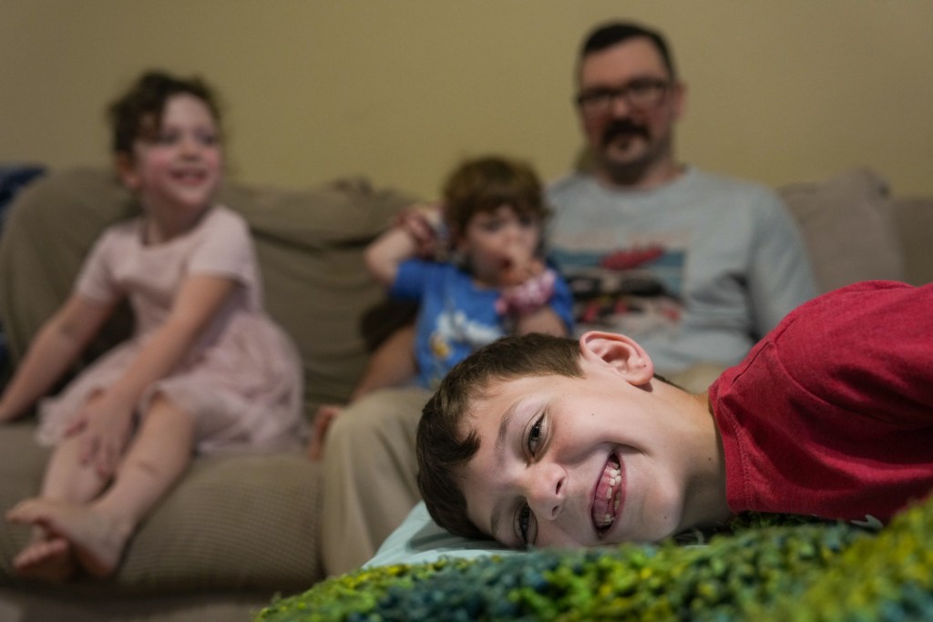 Henry Herzog, 7, jokingly poses during a portrait session with his family on Monday, March 9, 2026, at their home in Manvel.