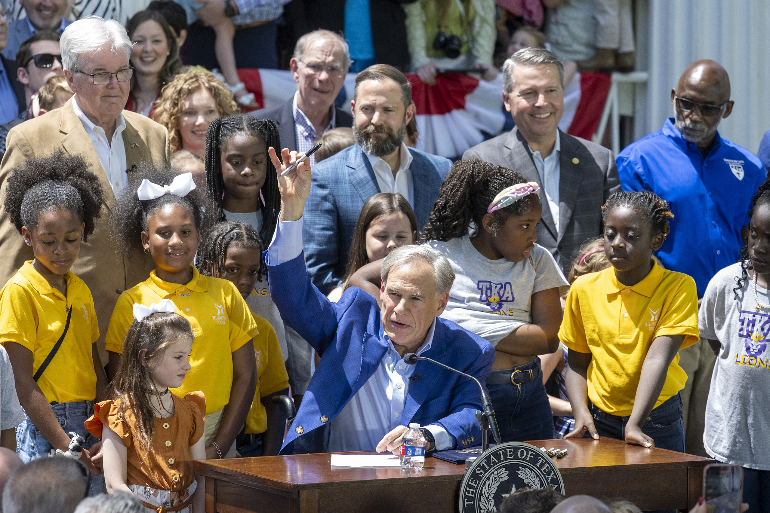 Gov. Greg Abbott signs SB2, the authorizing educational savings accounts (ESA's) to help parents pay private school tuition for their children during a ceremony at the Texas Governor's Mansion on May 3, 2025.