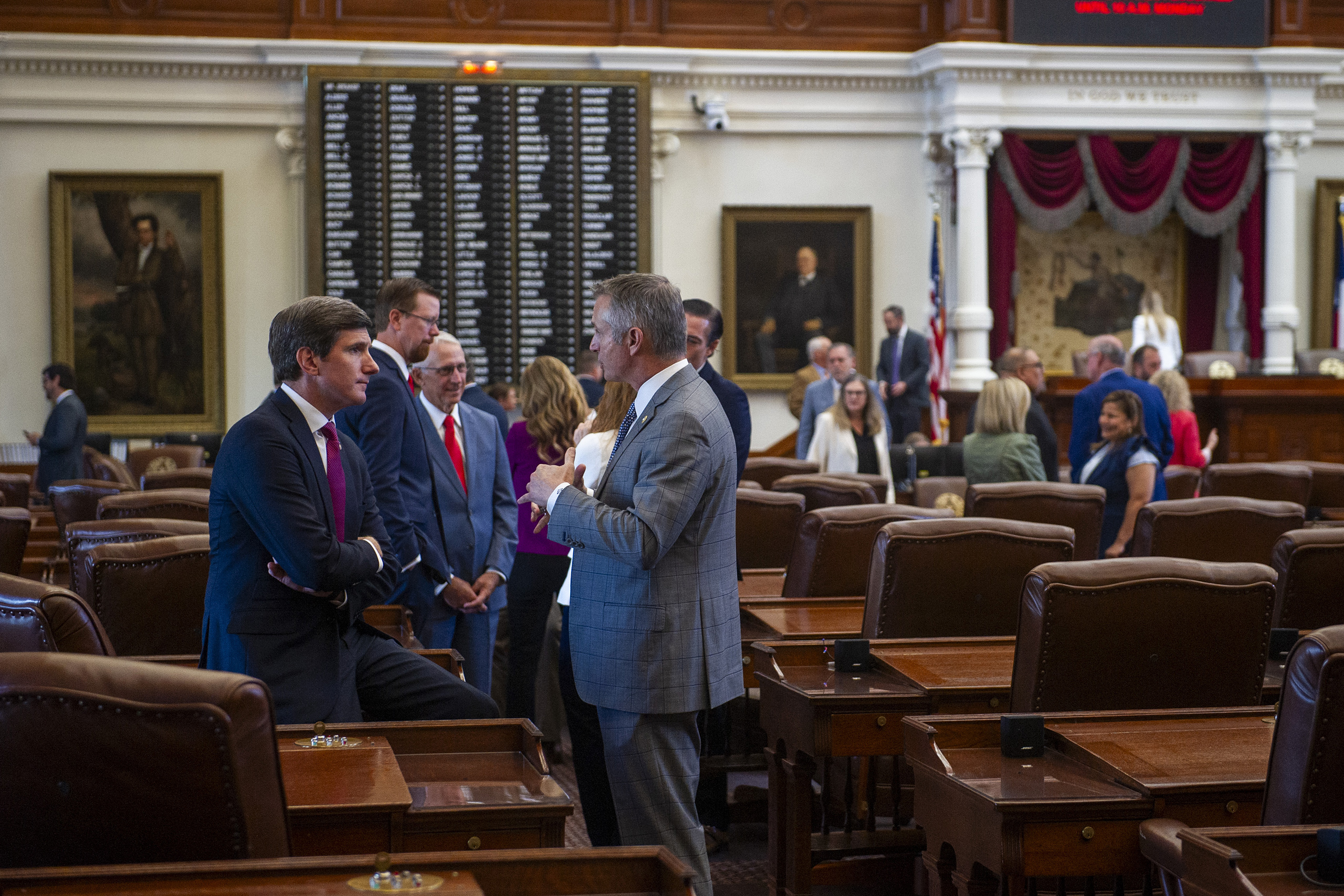 State Rep. Brooks Landgraf, R-Odessa, speaks with Rep. Tom Oliverson, R-Cypress, on the House floor in Austin on July 24, 2025.