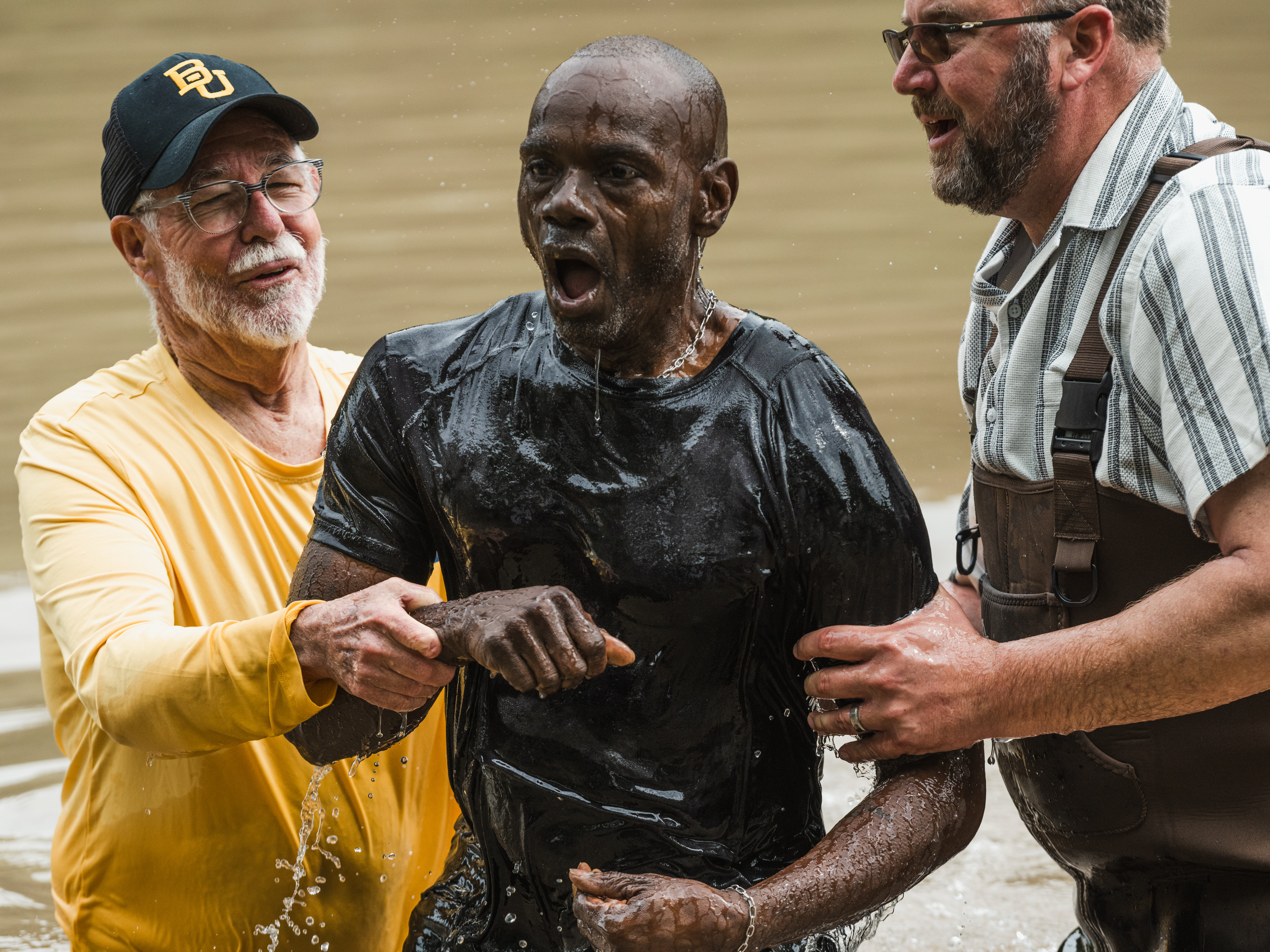 Roy Roberts is baptized in the Middle Bosque River by Jimmy Dorrell and Kevin Brown during Church Under the Bridge’s Easter service west of Waco.