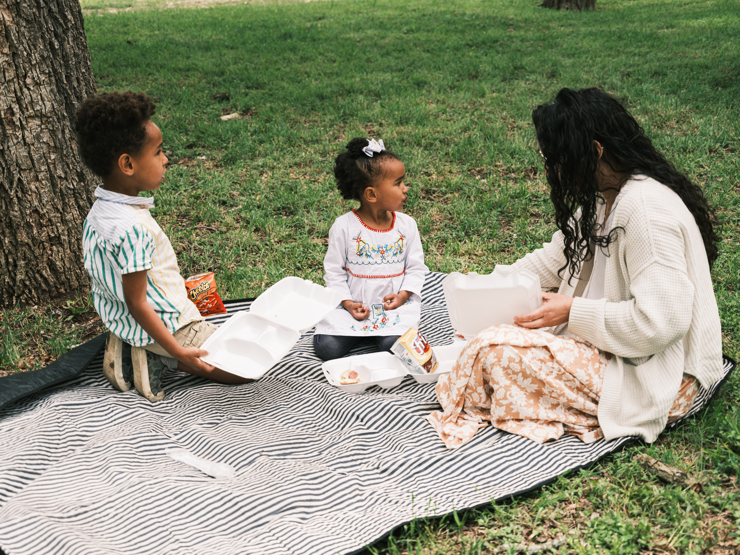 A family eats lunch after Church Under the Bridge’s Easter service.