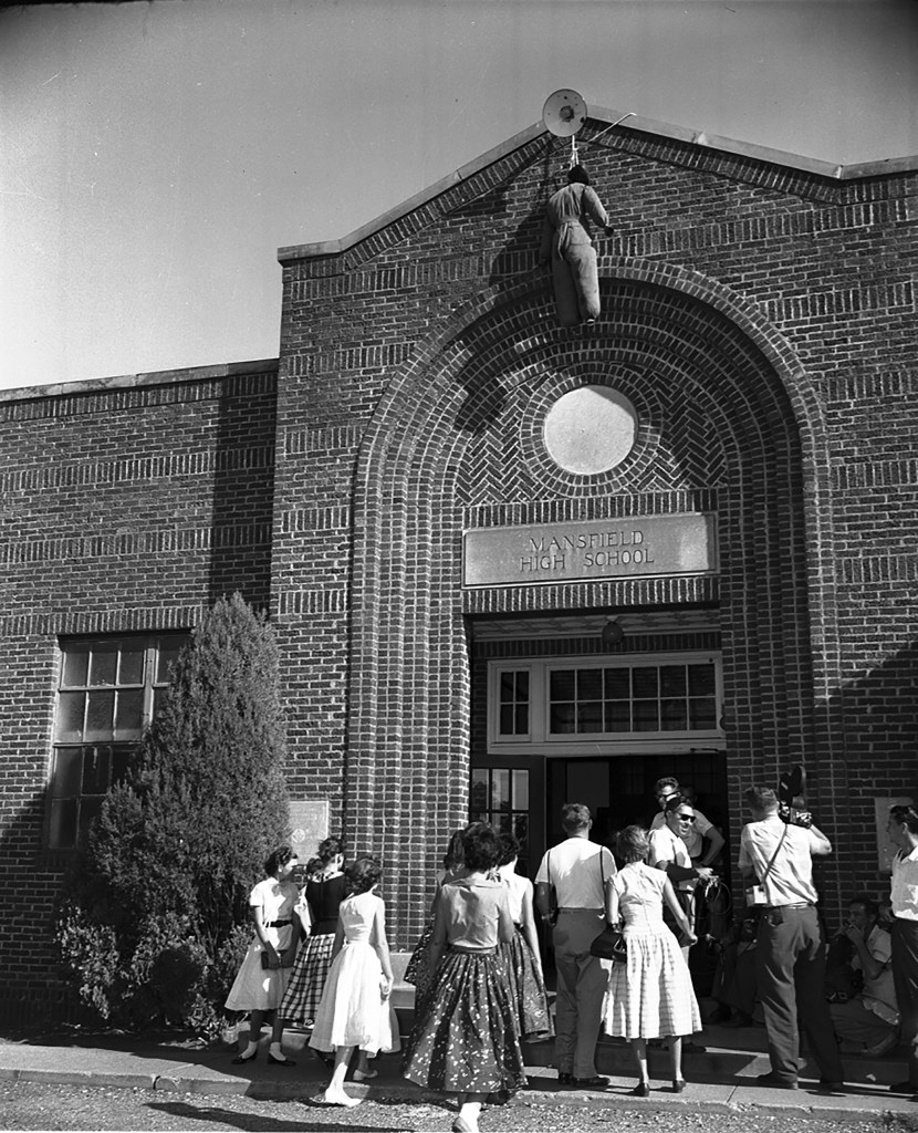 White students enter Mansfield High School with a figure painted black hanging in effigy over the entrance.