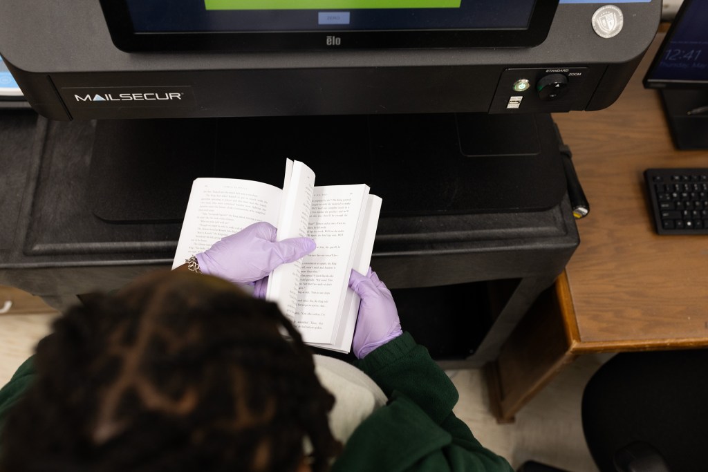 SLIDESHOW: TDCJ administrative assistant Alexis Page scans books in the mail room at the Wynne Unit in Huntsville to look for possible contraband.