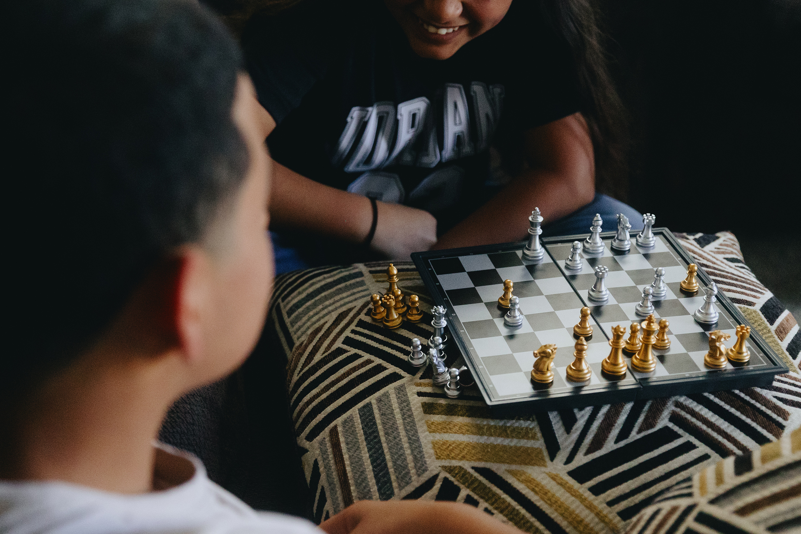 Y aged 10 and 14, play chess with each other at their home on June 27, 2026. The girl pictured learned to play chess while she and her brother were held in ORR custody for 400 days after trying to enter Texas from Honduras.