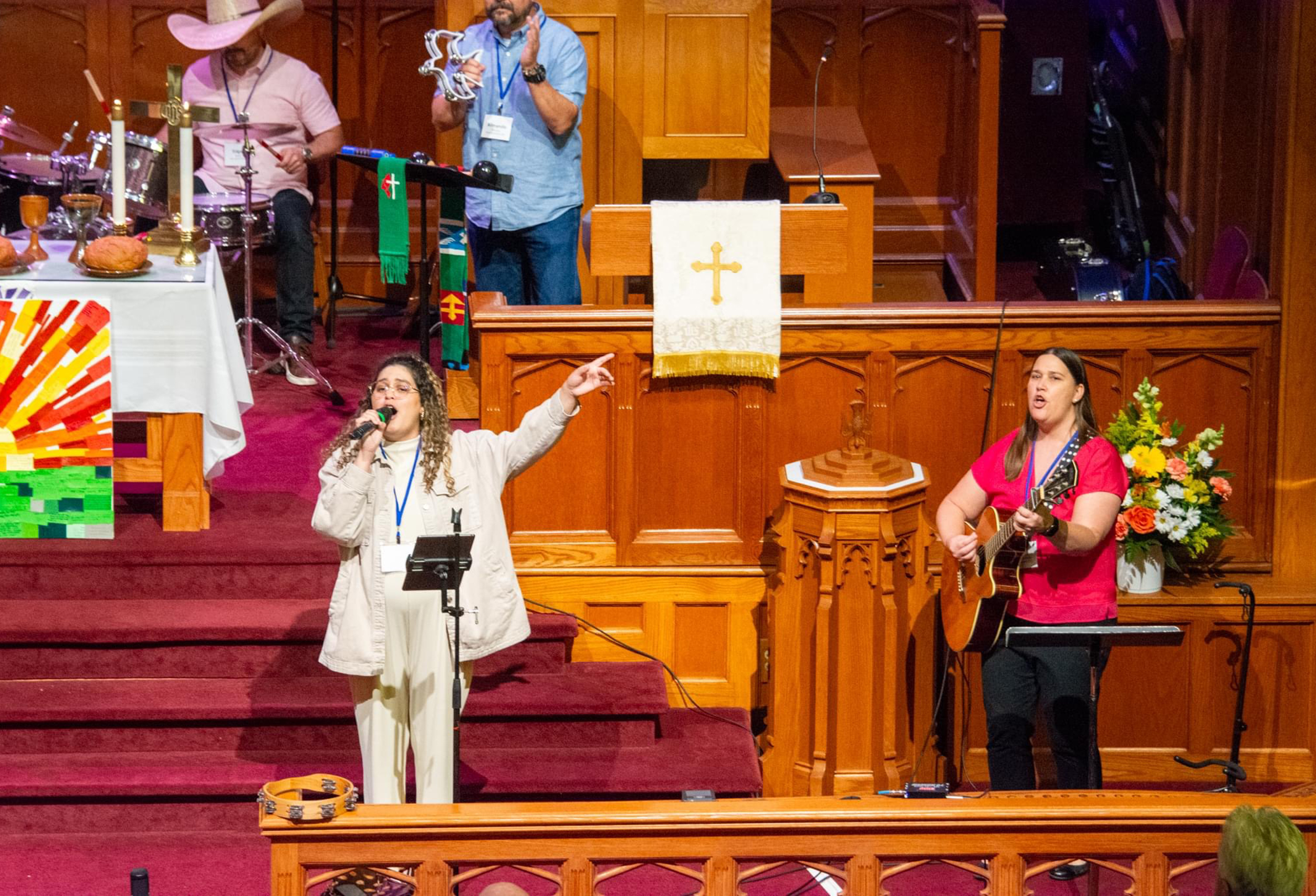 The Rev. Rosedanny Ortiz, left, sings during a worship service.