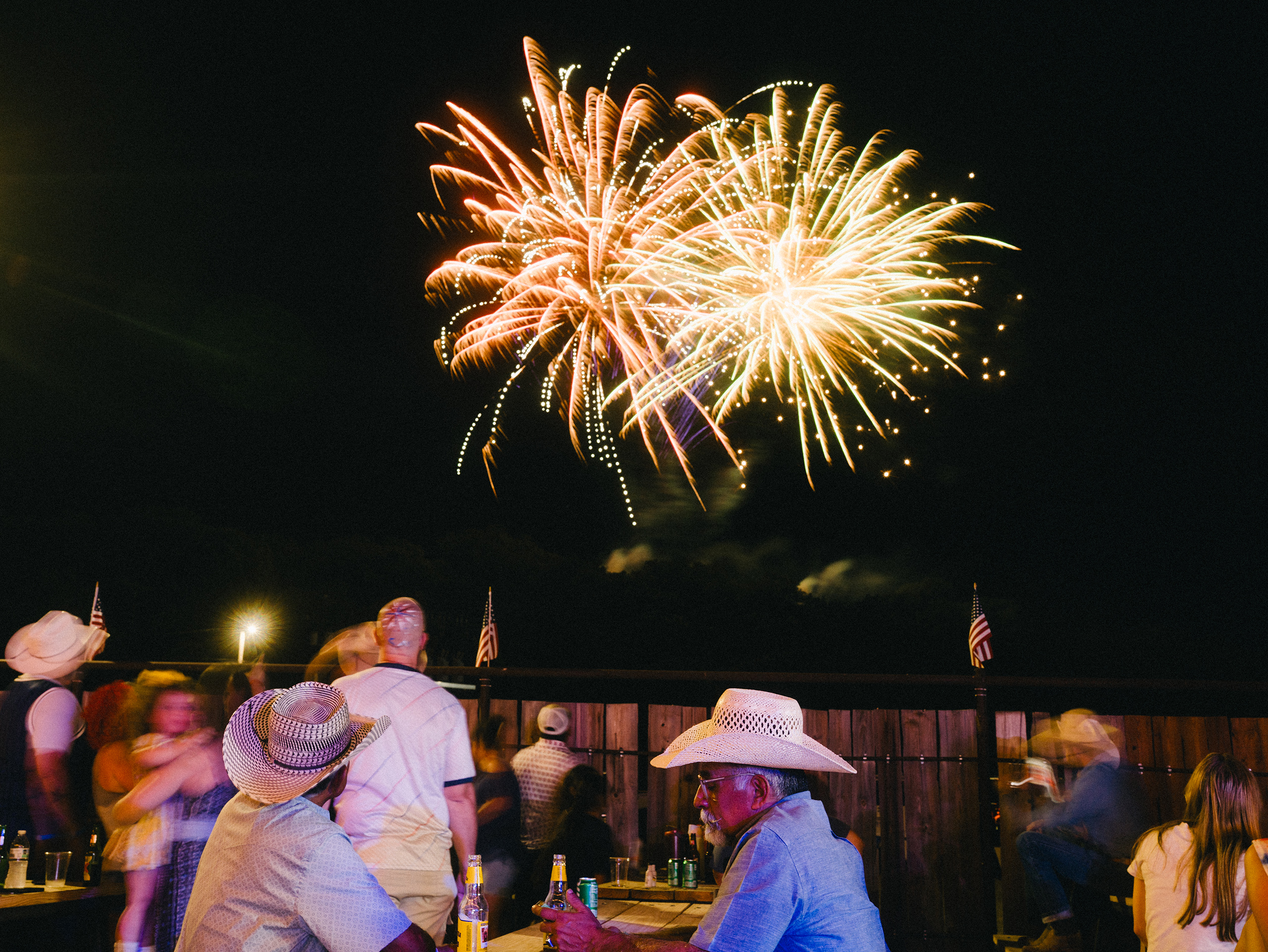 People watch the fireworks at Crider’s Rodeo and Dance Hall on the Fourth of July, 2026 in Hunt, Texas. A year ago, a devastating flood took the lives of 119 people in Kerr County.