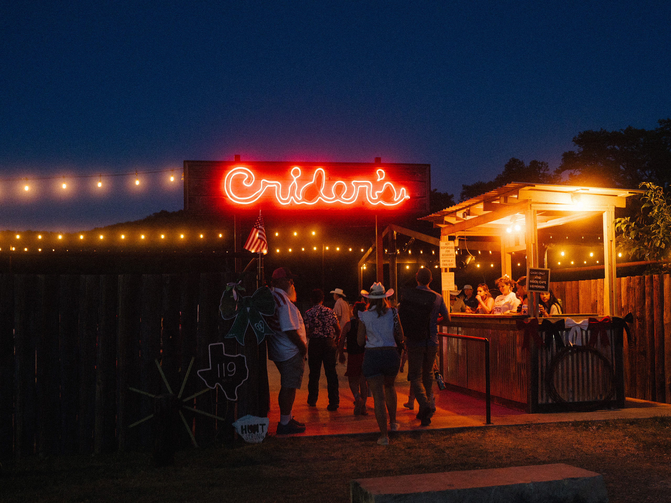 People arrive at Crider’s Rodeo and Dance Hall to celebrate the Fourth of July in Hunt, Texas on July 4, 2026. A year ago, a devastating flood took the lives of 119 people in Kerr County.