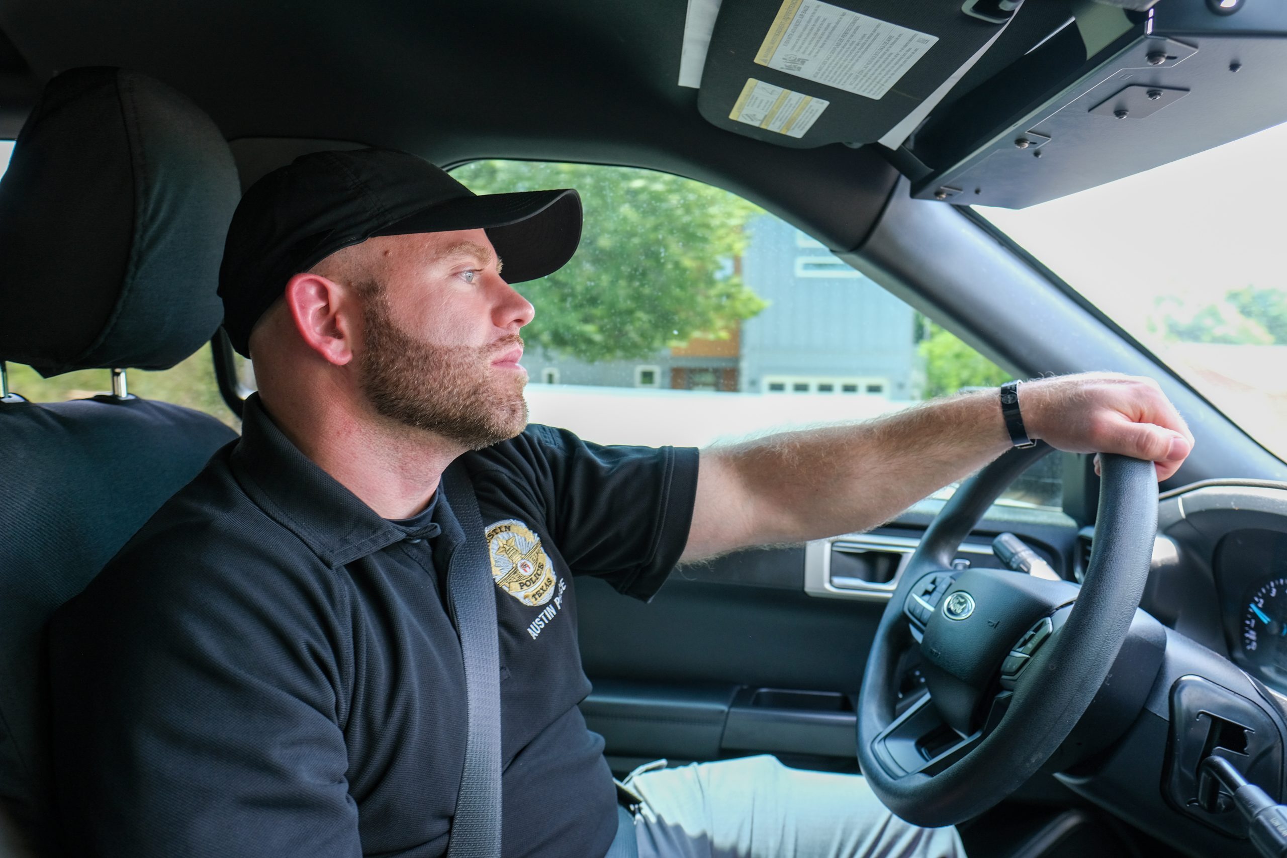 Austin Police Department Cody Martin drives in Austin, Texas on Thursday, August 6. APD Officer Edward Soltys is at left. Officer Martin is part of the No Wrong Door program, a new initiative seeking to better help some of Austin’s most vulnerable.
