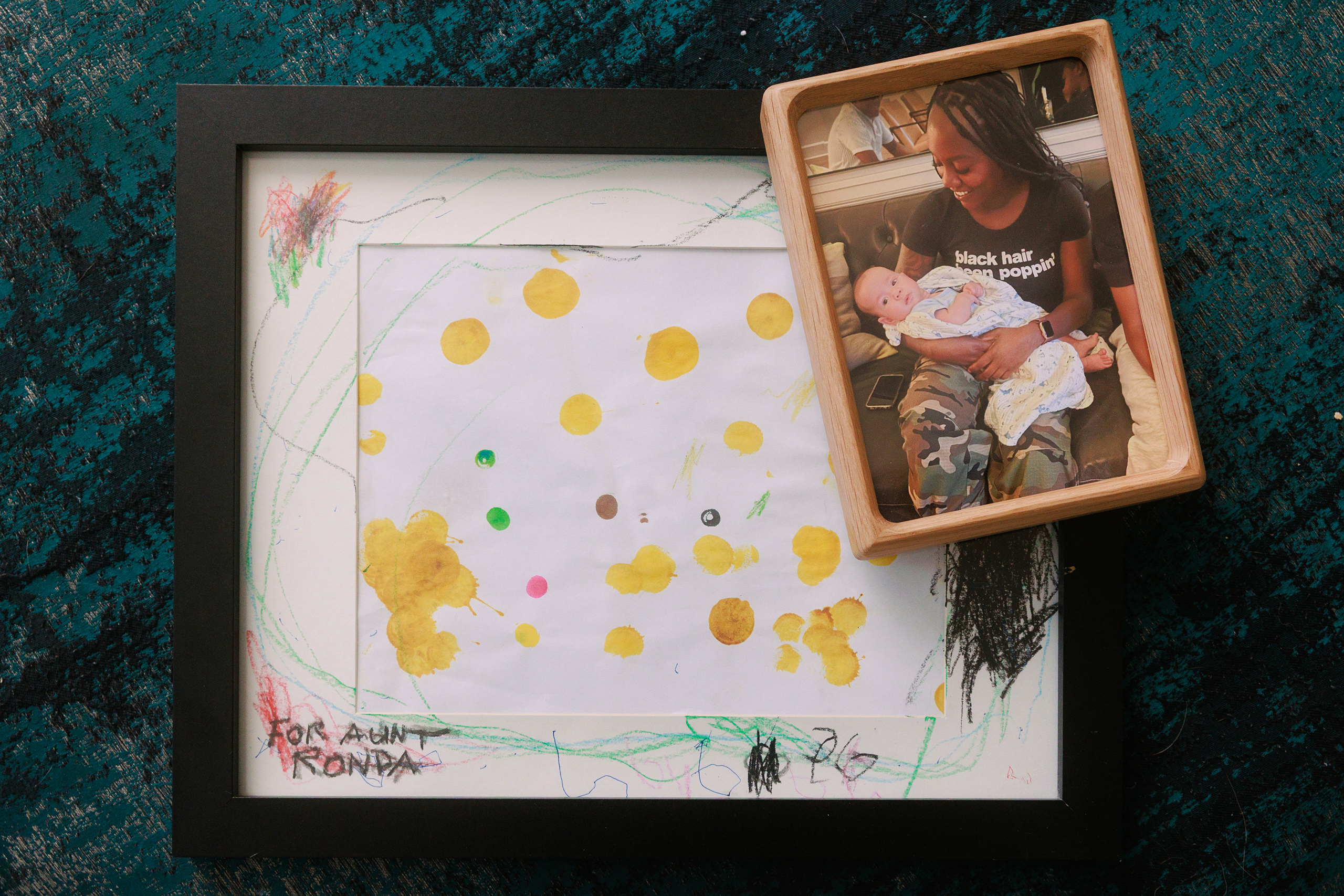 A piece of art that one of Ronda Young’s surrogates, PG, made for her when he was 3 years old and a photo of them together at her .
