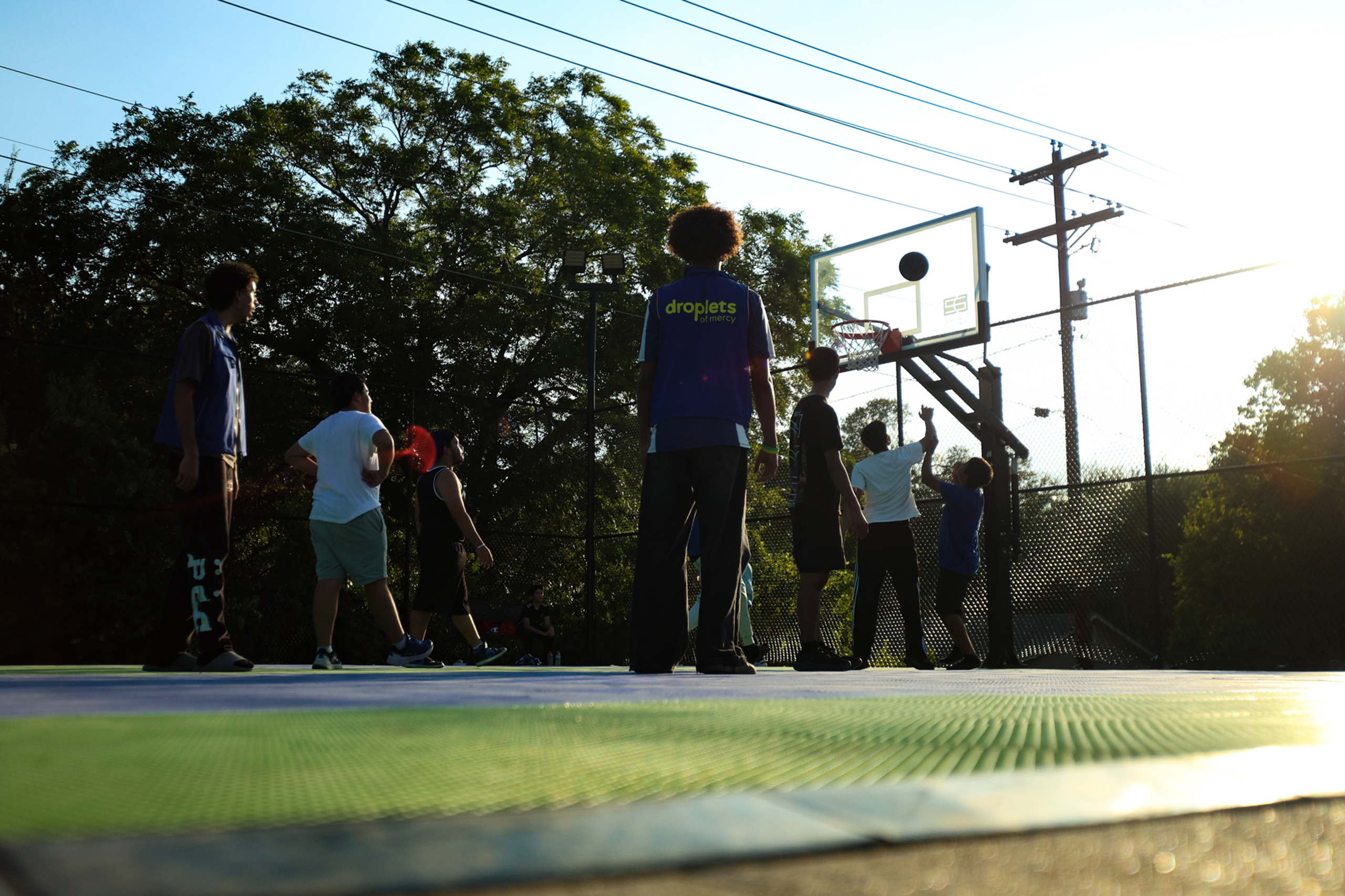 Children play basketball outside as a conference takes place inside at the North Austin Muslim Community Center-Masjid Aisha.