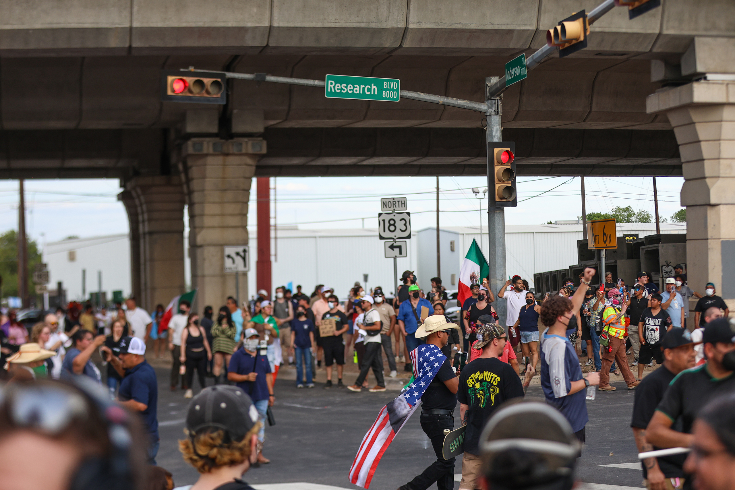 Protesters fill the intersection of West Anderson and Research Boulevard after an immigration enforcement agent shot and injured Wilber Rafael Garces Perez, 28, of Venezuela, on Sunday Sept. 20, 2026.
