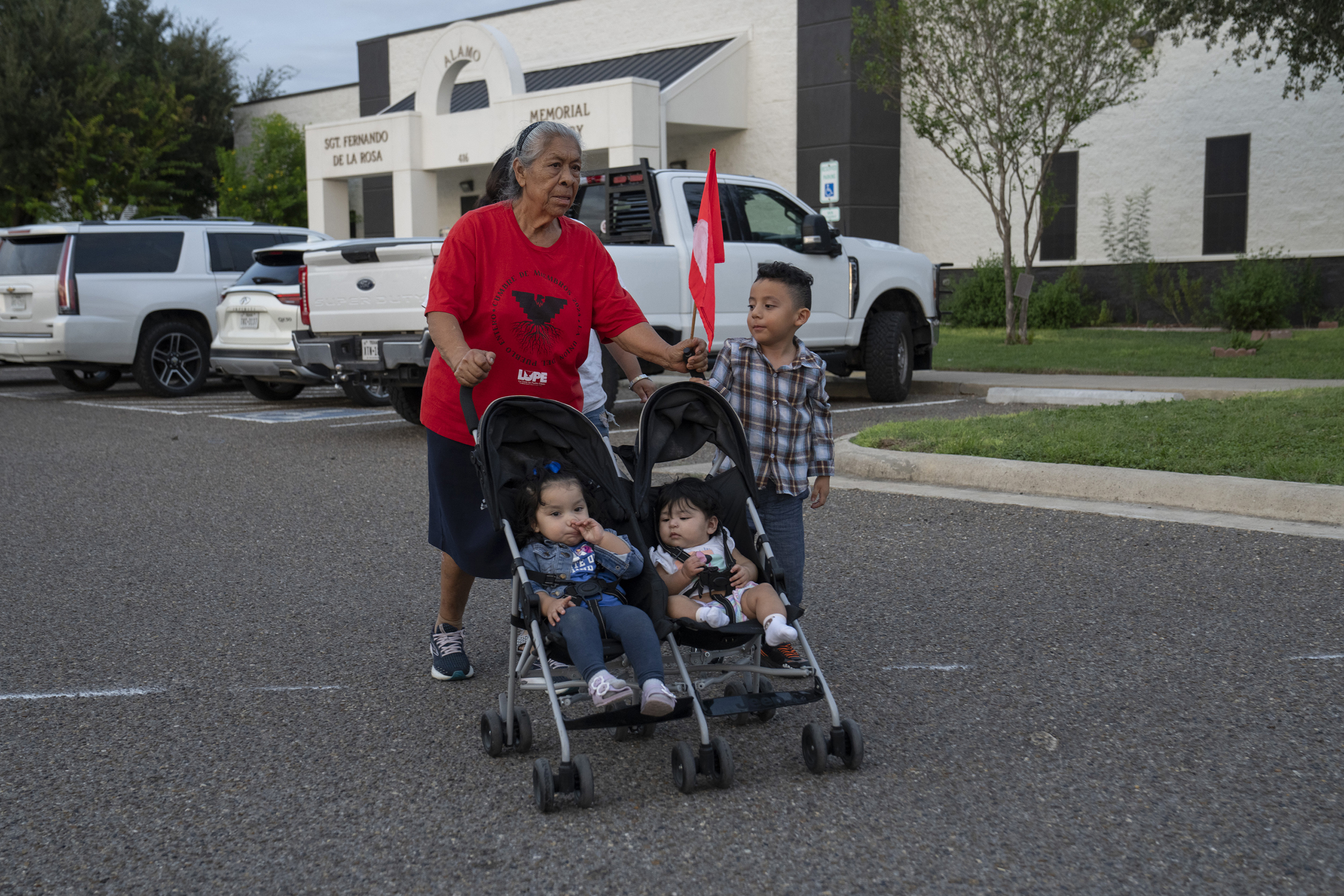 Maria Gomez, 78, walks from a polling site with the children of family and friends in Alamo on Oct. 19, 2026.